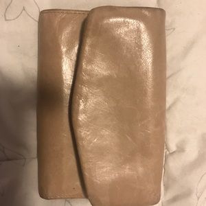 A cream Hobo wallet.